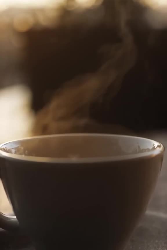 A coffee cup steam forms a tiny heart shape, melting with a soft 'hiss' sound. Warm morni…