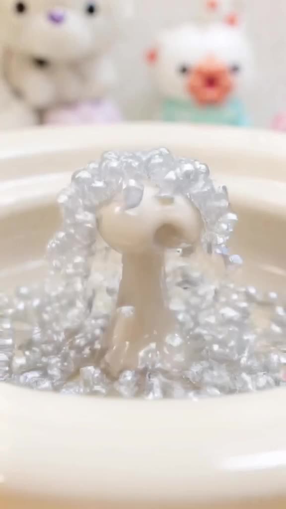 3D style. A fountain that sprays marbles instead of water. They clatter and roll into a p…