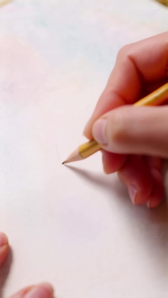 A pencil draws a line on paper, and the line lifts off the page to form a solid gold brid…