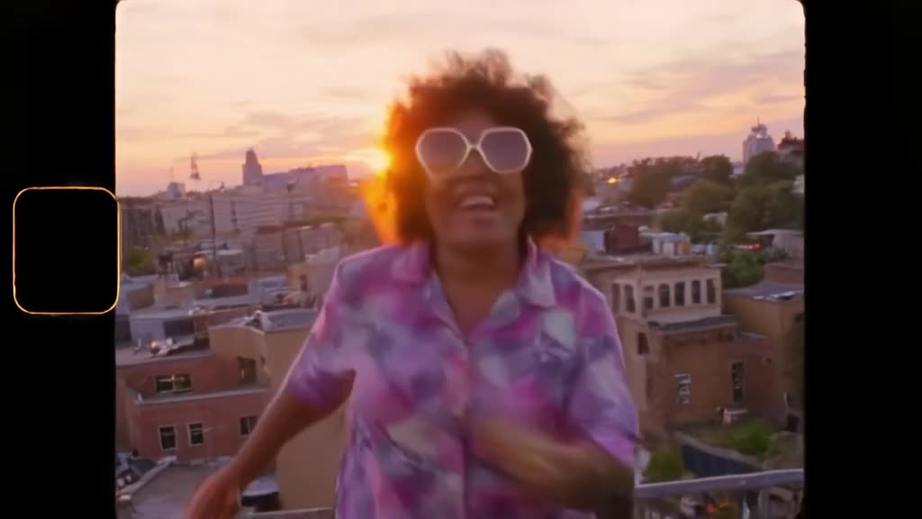 A grandma with oversized shades breakdances on a rooftop at sunset. Her afro bounces with…