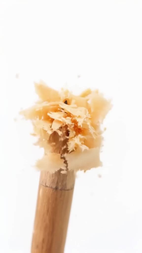 A pencil shaves itself, curls piling up like confetti with a sharp 'shave-shave' sound. B…