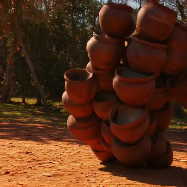 A stack of terracotta pots tips over in slow motion. As they hit the ground, they shatter…