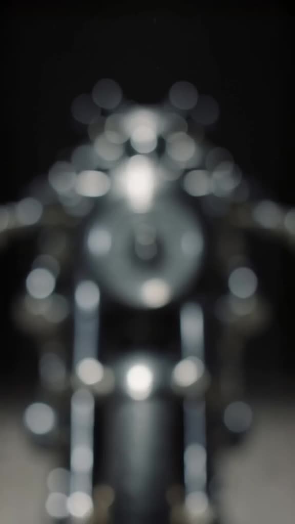Racing motorcycle zooms past the camera in a blur. It stops instantly, revealing it’s mad…