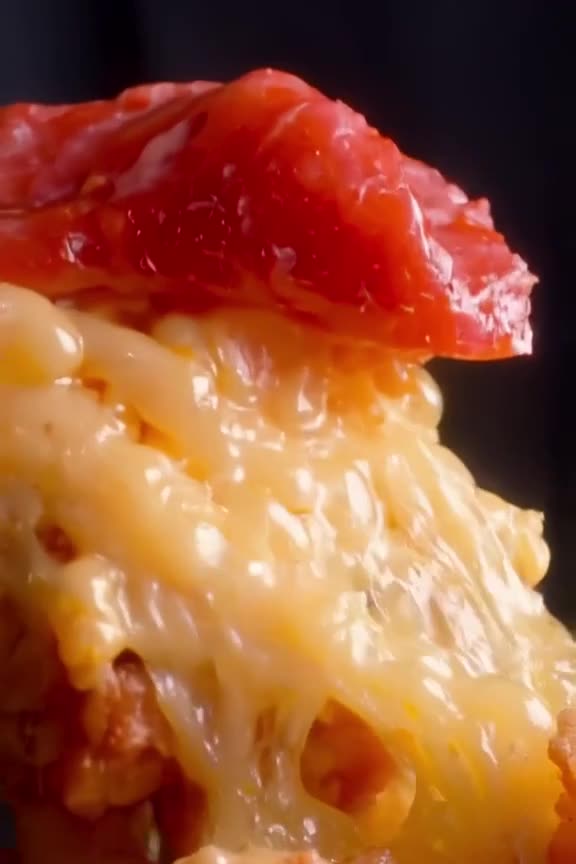 A juicy tuna melt sandwich explodes mid-air in slow motion, cheese stretching like elasti…