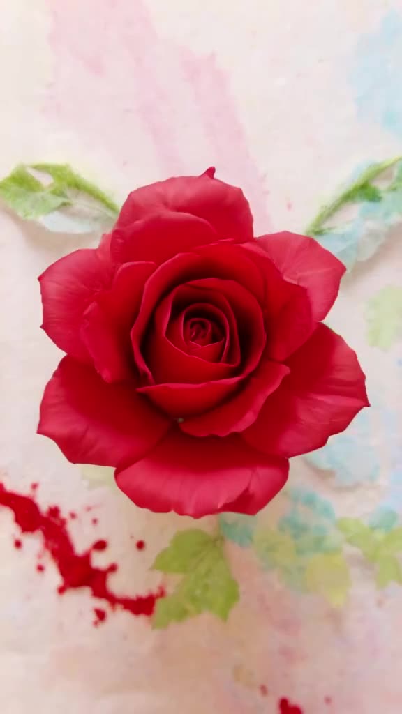 A drop of red dye falls into water, swirling into a perfect, hyper-realistic rose. The ca…