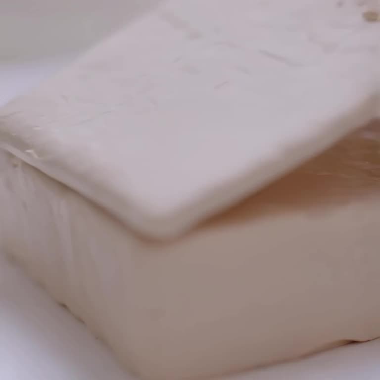 A skateboard is pressed into a block of soft, pastel-colored modeling clay. When lifted, …
