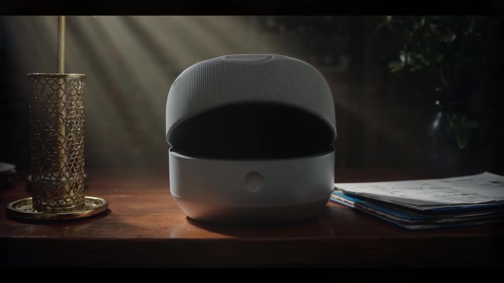A smart home speaker sits on a desk. Its grill expands like a mouth, singing operatically…