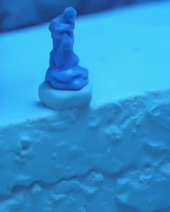 A tube of toothpaste squeezes out a string of blue paste. The paste morphs into a serene …