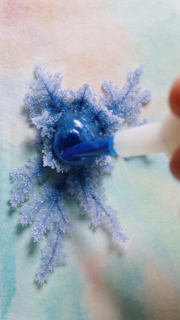 A dropper releases ink into water, creating perfect fractal patterns that look like under…