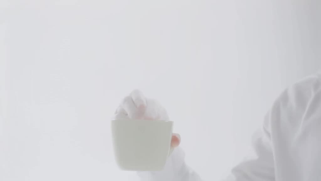 A robotic hand performs a finger snap challenge while holding a steaming mug perfectly st…