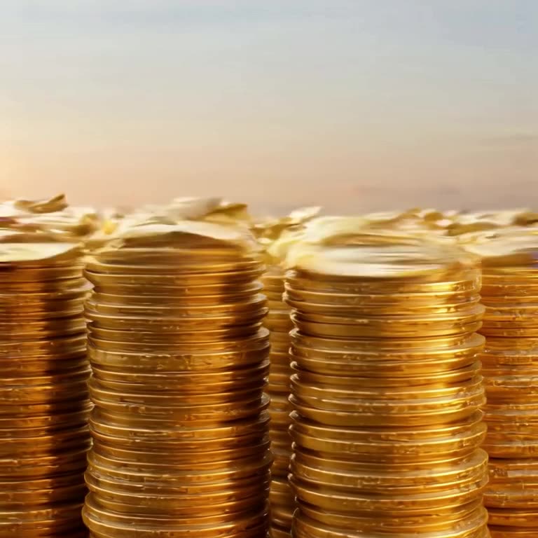 A pile of coins clinks and stacks itself perfectly tall. Golden afternoon light glints of…