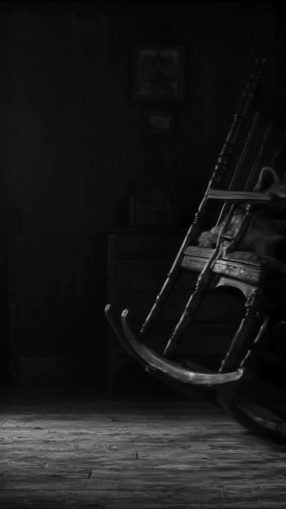 An old rocking chair moves by itself in a dark room. It stops to gently cradle a sleeping…
