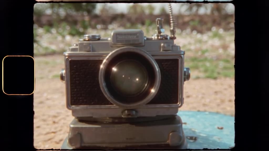 A vintage camera takes a picture of itself, and the flash reveals a tiny party inside the…