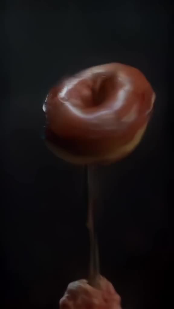 A donut spins on a fork like a basketball, then balances perfectly. Dark moody background…