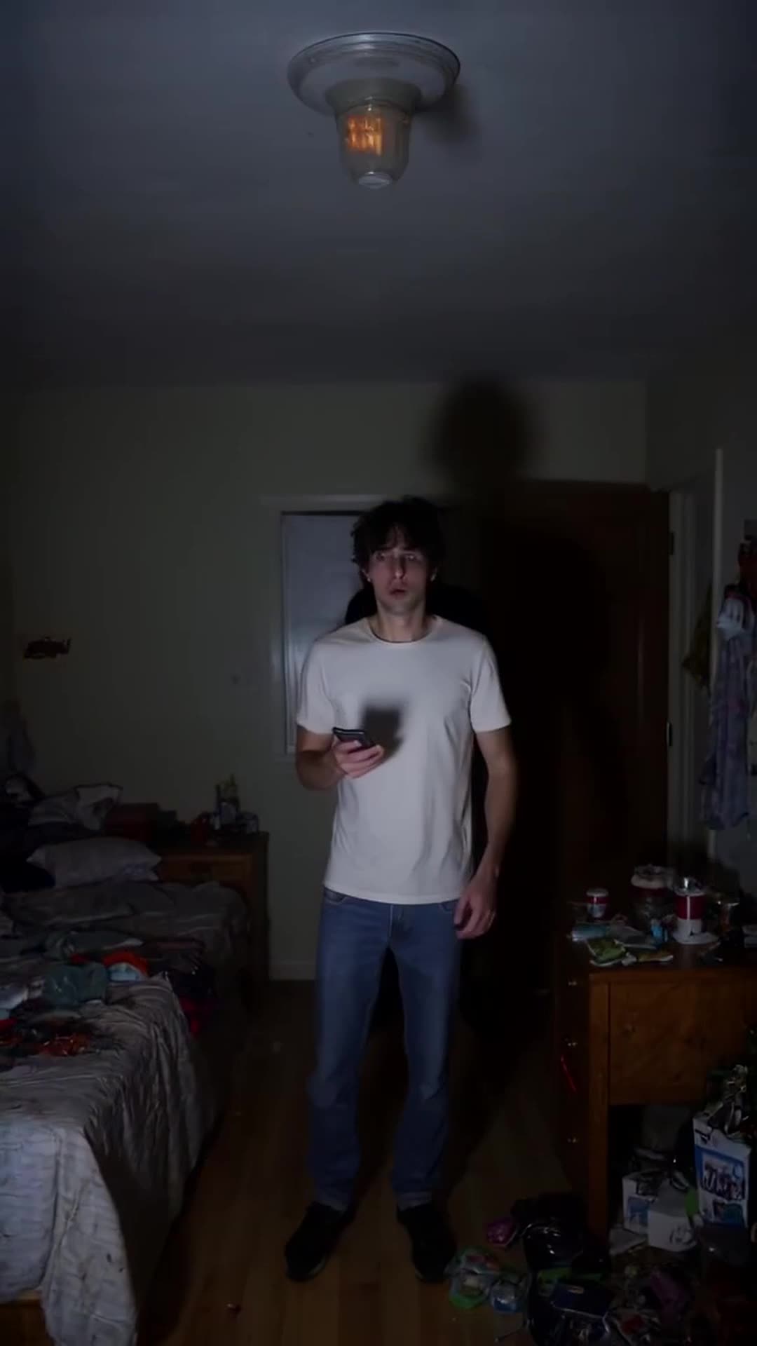 Create a 30-second vertical 9:16 ultra-realistic horror video. At 3 AM, a young man recei…